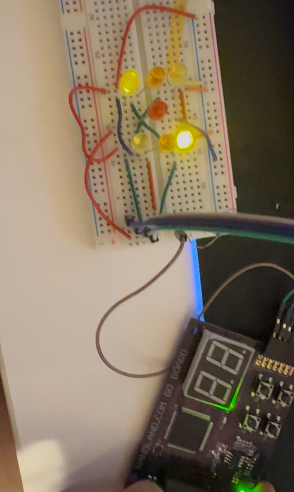 The physical build: Lattice ICE40 FPGA breakout with seven LEDs arranged in a dice pattern, plus a button and the shared series resistor.