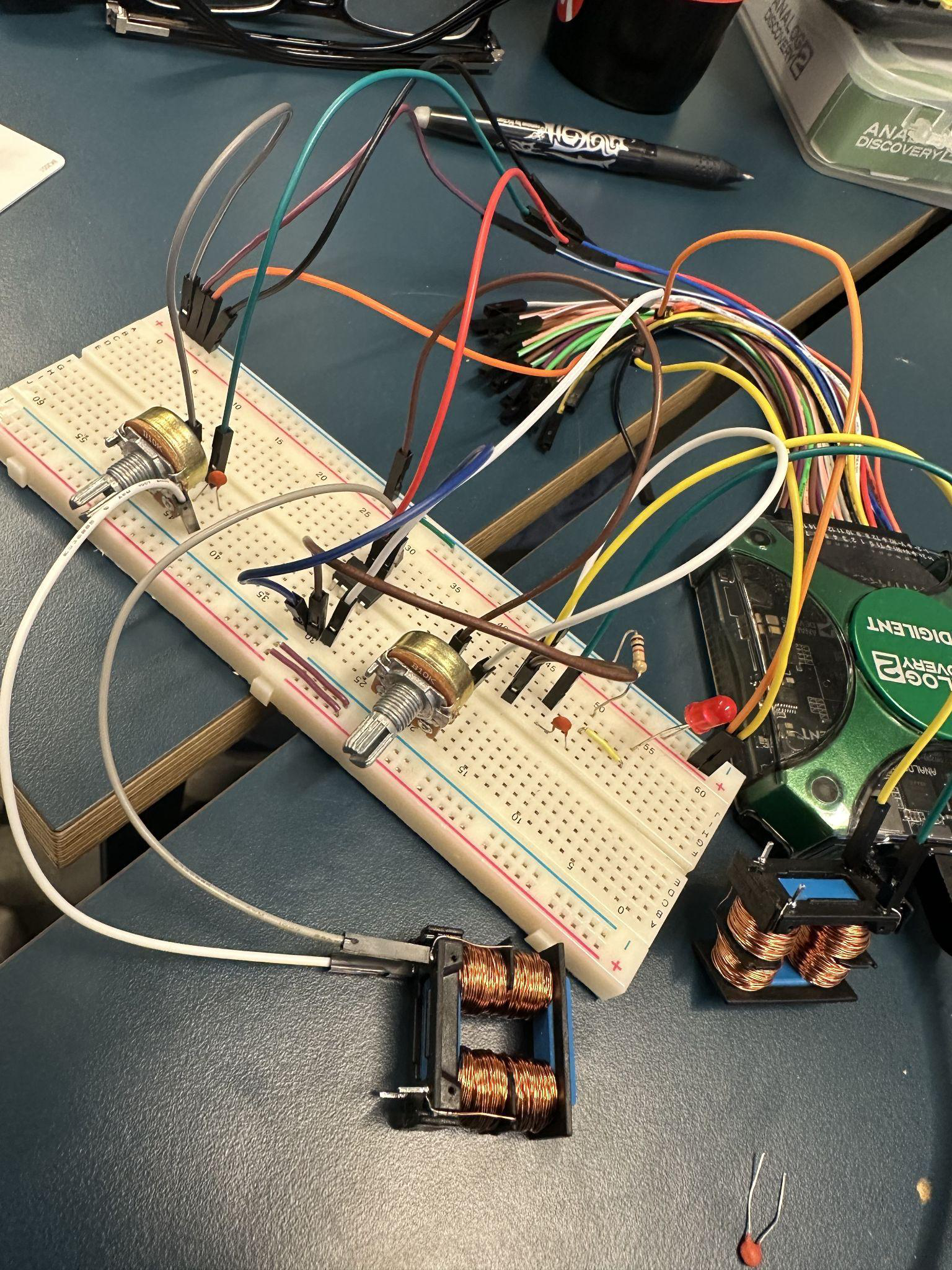 Breadboard with the analog frequency doubler wired up. Two hand-wound inductors on a custom 3D-printed mount; potentiometers for resistor tuning.